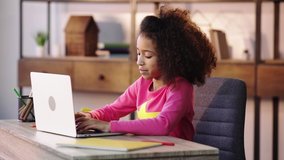 african american child doing homework on laptop
