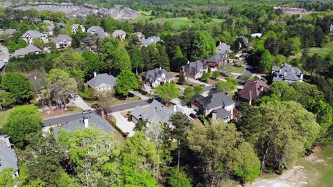4K video of Aerial view of an upscale sub division with cluster of houses in suburbs of Atlanta, GA, USA