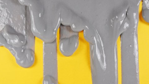 Ultimate Gray Paint Color With Flowing On The Plain Illuminating Yellow Surface. Color of the year 2021