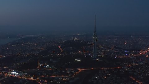 Wide View of Huge New TV Tower of Istanbul with Mosque on Hill in Background at Night, Aerial Drone Shot, ISTANBUL, TURKEY, SEPTEMBER 16th 2020