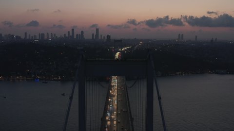Establishing Shot of Bridge leading into the City of Istanbul at Dusk with Skyscraper Skyline Silhouette, Aerial Establisher forward