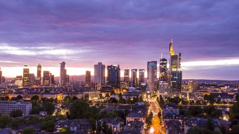 AERIAL: Night Hyper Lapse, Motion Time Lapse of Frankfurt am Main Germany Skyline view and beautiful city lights with Main River in foreground circa june 2020