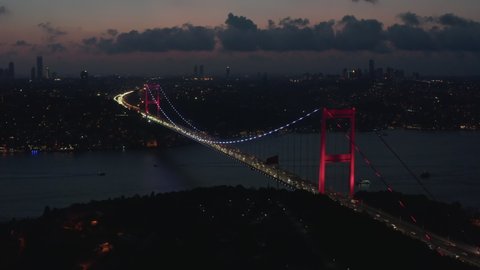 Wide Establishing Shot of Bosphorus Bridge illumination in Red light in Istanbul, Turkey, Aerial