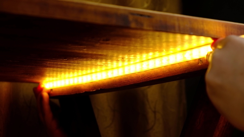 Installation of LED strip under the table. High quality 4k footage | Shutterstock HD Video #1069712395