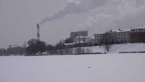 The First Cathedral Mosque Kazan Tatarstan. minaret. Roofs in snow . The Old-Tatar Quarter Sloboda settlement in Kazan. Old wooden houses. Winter snow. Pipe with smoke. Panorama video from frozen Lake