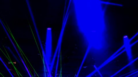 Laser neon music light rays flash and glow in the banquet hall. 4K