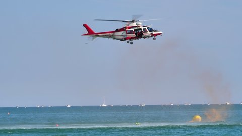 Jesolo, Italy 09.15.2019 - Italian firefighters in Rescue Helicopter Agusta A109E Power performing a sea rescue demonstration. High quality 4k footage