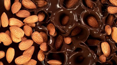 Super Slow Motion Shot of Almonds Falling into Melted Chocolate at 1000 fps.