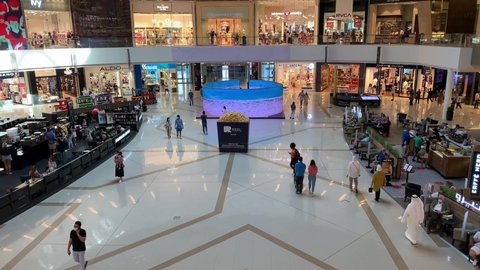 Dubai - UAE - September 25, 2020: Marina Mall indoor with many people, cafes, and shops. The crowd in Marina Mall. Top view.