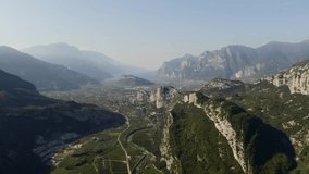 A gorgeous view from the air on the Treni mountain range in northern Italy. In the distance is Lake Garda. Mount Grotta. The city of Riva del Garda. Video from the drone. Flying over the Alps.