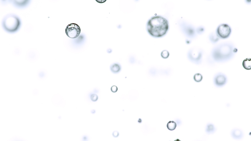 Macro shot of various air bubbles in water rising up on white background. | Shutterstock HD Video #1069735771