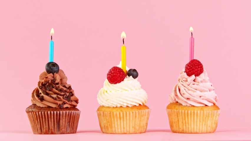 Birthday Cup Cakes With Burning Colorful Candles on Pastel Pink Background. Royalty-Free Stock Footage #1069735891