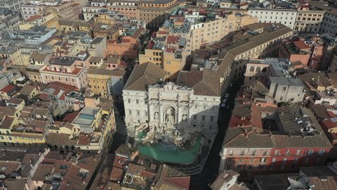 Aerial view of the Trevi Fountain or Fontana di Trevi, baroque landmark in the center city of Rome, Italy. Famous tourist attraction in Roma, Italia seen from drone flying in the sky