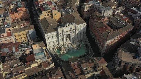 Aerial view of the Trevi Fountain or Fontana di Trevi, baroque monument in the center city of Rome, Italy. Famous tourist attraction in Roma, Italia seen from drone flying in the sky