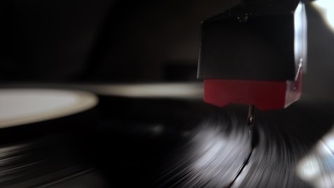 The needle of a turntable record player in close-up - studio photography