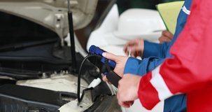 Professional team mechanic car repair service and checking car engine by Diagnostics Software computer. Expertise mechanic working in automobile repair garage. - Powered by Shutterstock - Get 15% off with code: PIKWIZARD15