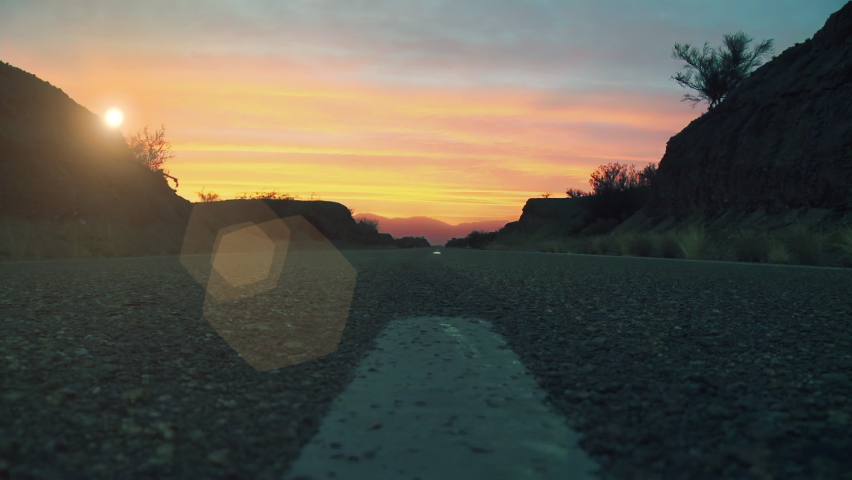 Pick Up Vehicle on a Desert Road driving Towards Sunset. 4K Resolution. Royalty-Free Stock Footage #1069754659