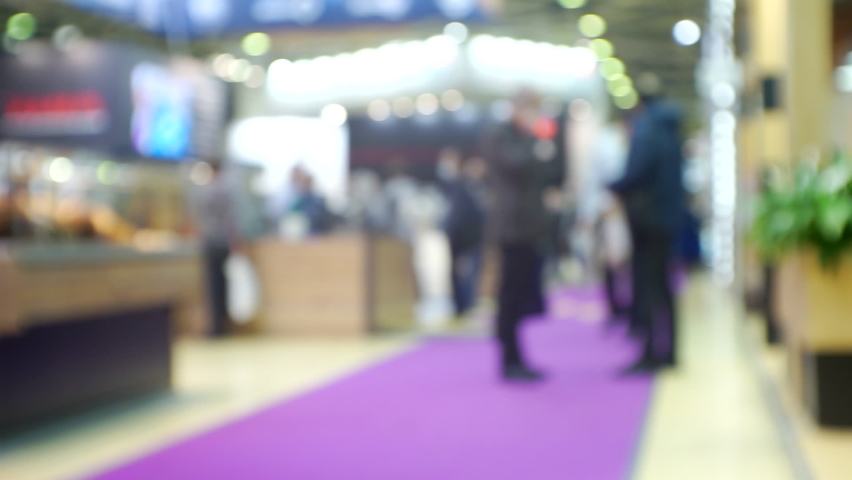 Modern city life. Abstract blurred background on business theme. Blurry defocused video. Unrecognizable people in a large modern building.