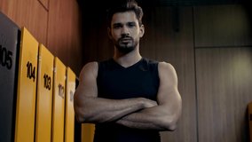 sportsman with crossed arms in locker room