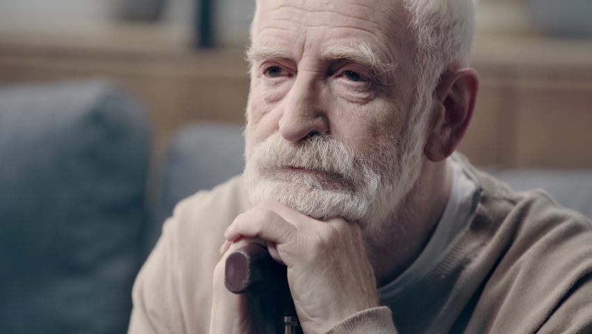 Upset senior man with dementia holding walking stick | Shutterstock HD Video #1069761466