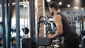 bearded sportsman exercising in gym