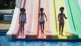 group of happy african american kid runing and jumping on dry waterslide to swiming pool at water park together in summer holidays Before opening time - Powered by Shutterstock - Get 15% off with code: PIKWIZARD15
