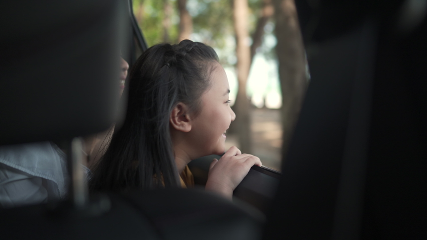 4K Happy Asian family enjoy outdoor lifestyle travel together on summer road trip vacation. Little child girl kid and mother sitting in the car looking out of the window to the beach in sunny day | Shutterstock HD Video #1069779757