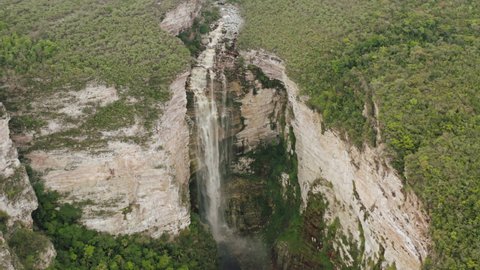 Aerial footage of remote waterfall surrounded by dense forest. Encantada Waterfall. Chapada Diamantina National Park. Itaetê, Bahia, BA, Brazil