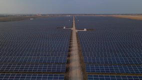 Aerial drone view into large solar panels at a solar farm at early spring sunset. Solar cell power plants. footage video 4k.