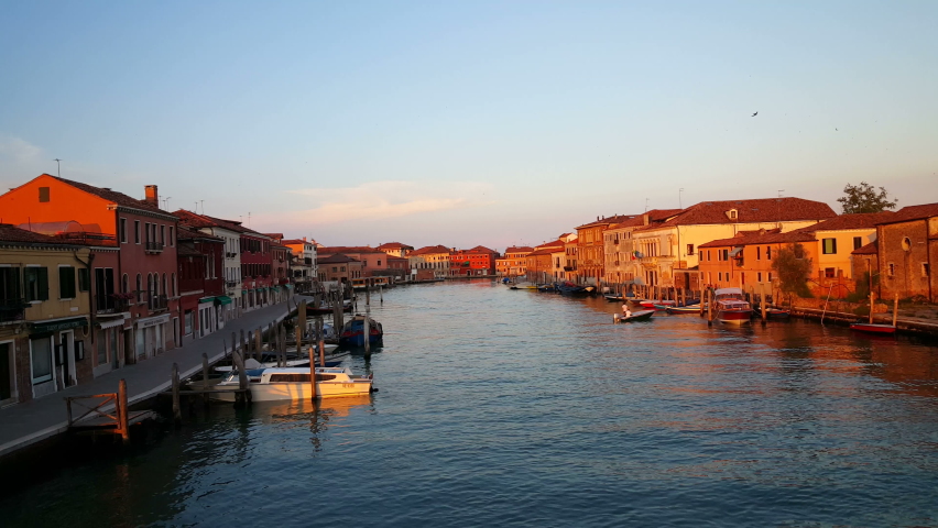 Water taxi passing by in canal of Murano