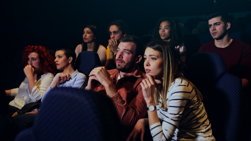 Group of people watching sad movie in cinema. Royalty-Free Stock Footage #1069796650