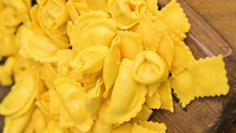 Fresh homemade pasta. Different Tartollini with cheese or meat for cooking in broth, different shapes. Traditional dish for celebrations in italy, Emilia Romagna region. Vertical video,social networks