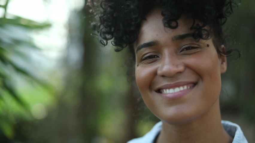 Happy Brazilian young black African woman portrait smiling. | Shutterstock HD Video #1069798531