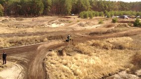 Motorcyclists on the motocross track, ride off-road and jump over sandy hills. drone video 4k