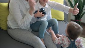 caucasian family little children girl boy and mom talking in video conference by smartphone together in living room at home with happiness smile. activity technology lifestyle mobile phone use concept
