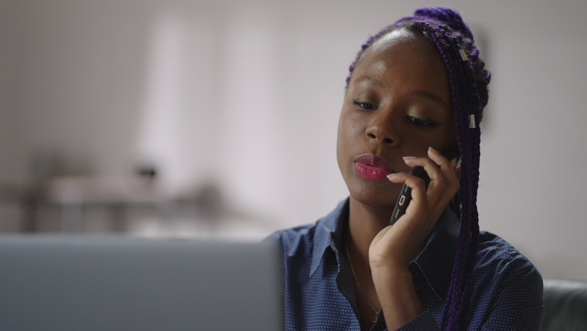 young afro-american entrepreneur woman or sales manager is calling by mobile phone, working in home office, chatting by cellphone, portrait of female business person Royalty-Free Stock Footage #1069817491