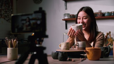 A young Asian woman ceramist is showcasing new pottery works via social media.