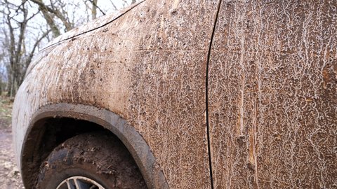 Close-up of the dirt on the car after driving through the mud. Off-road vehicle after driving on liquid mud