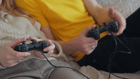 Woman man hands with gamepads playing video games unrecognizable people closeup