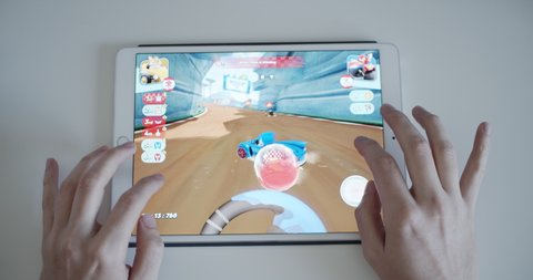 Sofia, Bulgaria, March 2021 - Gamer playing Sonic Racing on iPad tablet