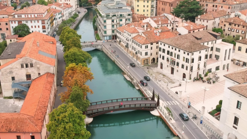 AERIAL: Smooth fly over Treviso, Italy. View of the canals and bridges during summer holidays. | Shutterstock HD Video #1069837090