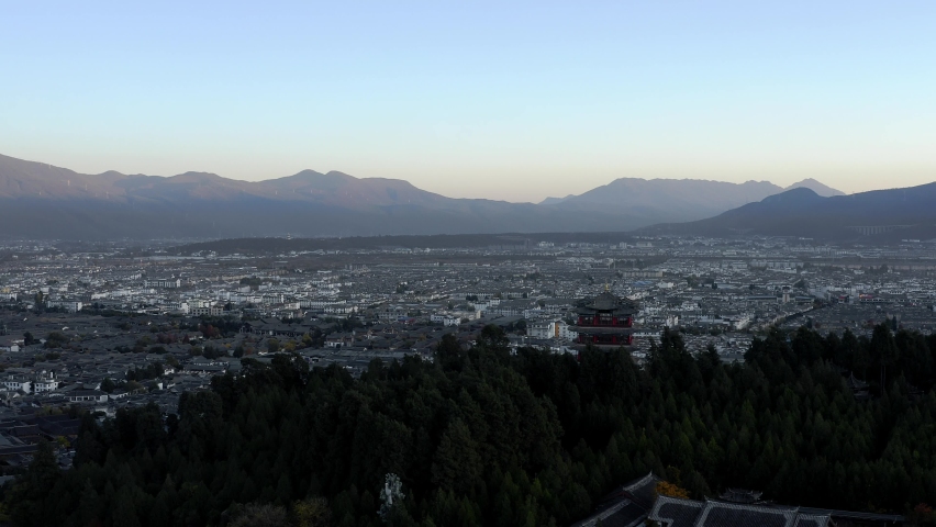 Lijiang city Jade Dragon Mountain in Yunnan province China, sunset aerial view