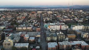 Cinematic aerial drone footage of Capitol Hill, Pike Pine, First Hill, Cherry Hill, Squire Park Minor, Cal Anderson Park, Madrona, Lake Washington, downtown at sunset in King County, Washington