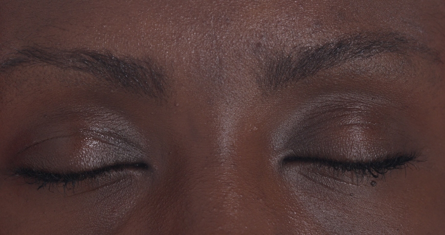 Youth, beauty - black woman eyes open and stare at the camera - macro | Shutterstock HD Video #1069839070