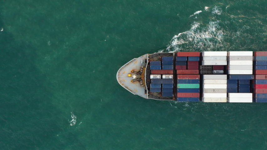 Aerial of smart cargo ship carrying container and running for export goods from cargo yard port to other ocean concept freight shipping ship and related to marine insurance,Logistics Supply Chain Royalty-Free Stock Footage #1069839541