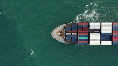 Aerial of smart cargo ship carrying container and running for export goods from cargo yard port to other ocean concept freight shipping ship and related to marine insurance,Logistics Supply Chain