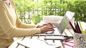 Young people work from home with laptop and drinking coffee in garden nature at home. Asian woman meeting conference connect online with office.  Business and Technology Concept