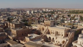Drone video over historic buildings in the architectural style of the Middle East. beautiful cityscape with houses and streets in mesopotamia. Aerial view Turkey.