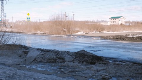 29.03.2021, Russia, Chelyabinsk: Large puddle melts on the city roadway. City authorities, utilities.