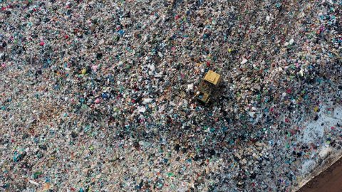 City Dump. The Bulldozer Compacts the Garbage on the Landfill. Wastes of Human Life. Ecology pollution concept. Aerial view